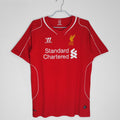 Red soccer jersey on hanger, V-neck, Standard Chartered print, LFC crest.