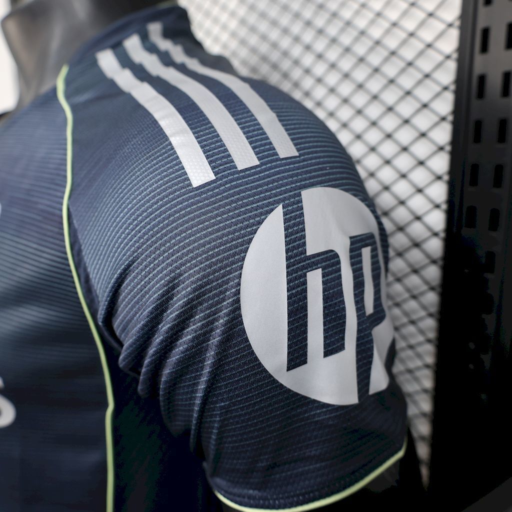 Adidas logo and sleeve graphic on navy Real Madrid away player jersey