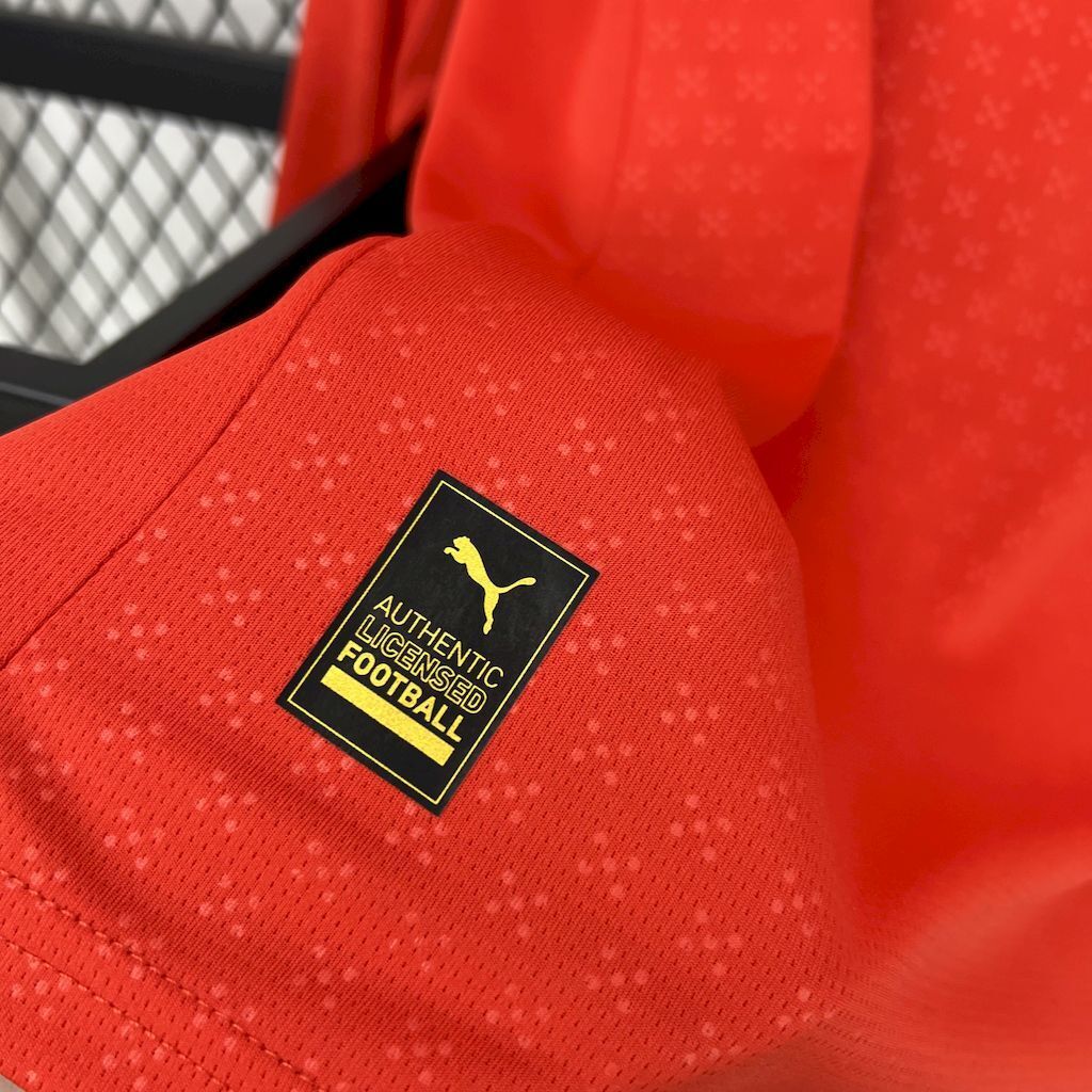 Red long-sleeve jersey sleeve patch with Puma Authentic Football wording