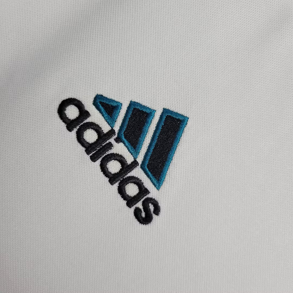 Adidas logo patch on white fabric of retro football jersey