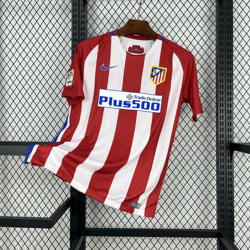 Red and white striped Atletico home soccer jersey with Nike swoosh and Plus500 sponsor