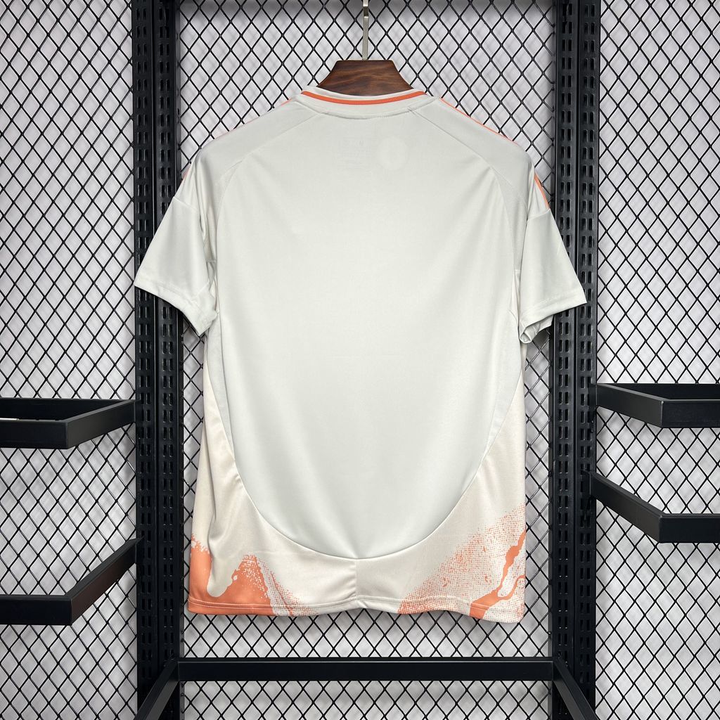 Away football shirt back view, white with orange abstract trim at the hem