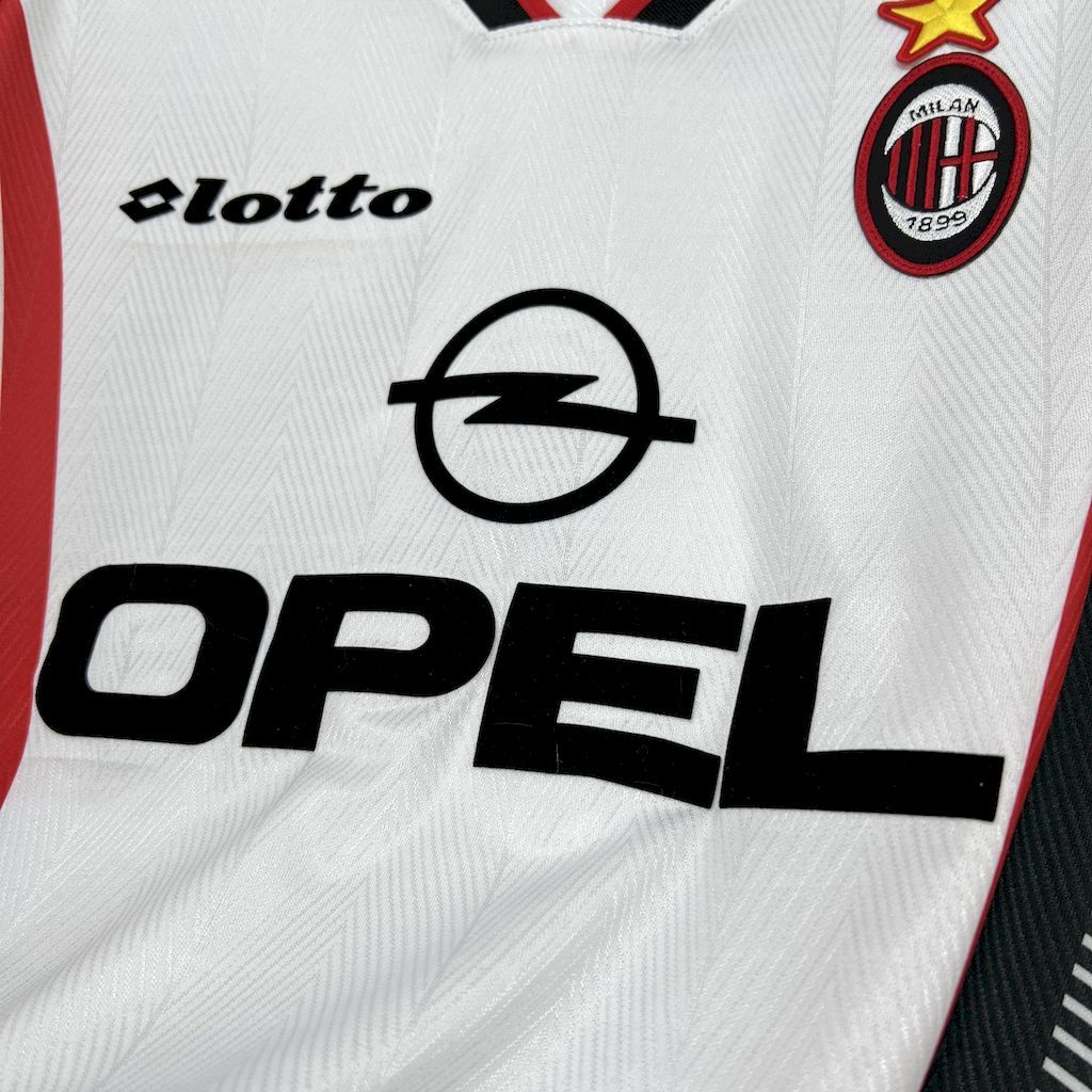 Front close-up showing Lotto logo, large OPEL sponsor text, and AC Milan crest