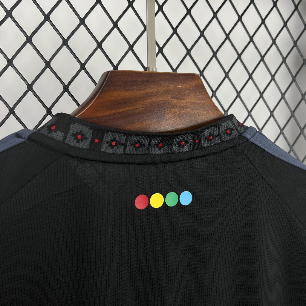 Black football jersey collar with patterned trim and multicolor dot accents