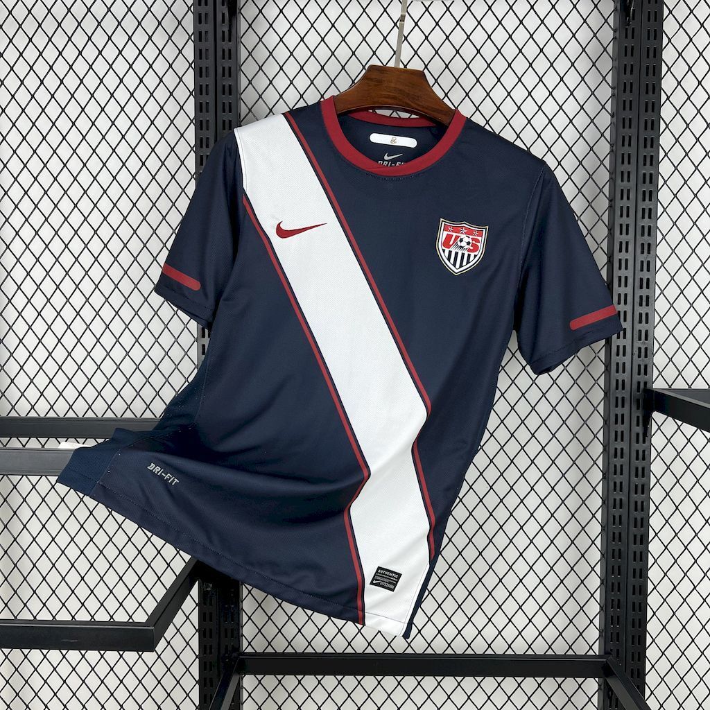 Navy soccer jersey with white diagonal stripe and red trim, USA crest on front.
