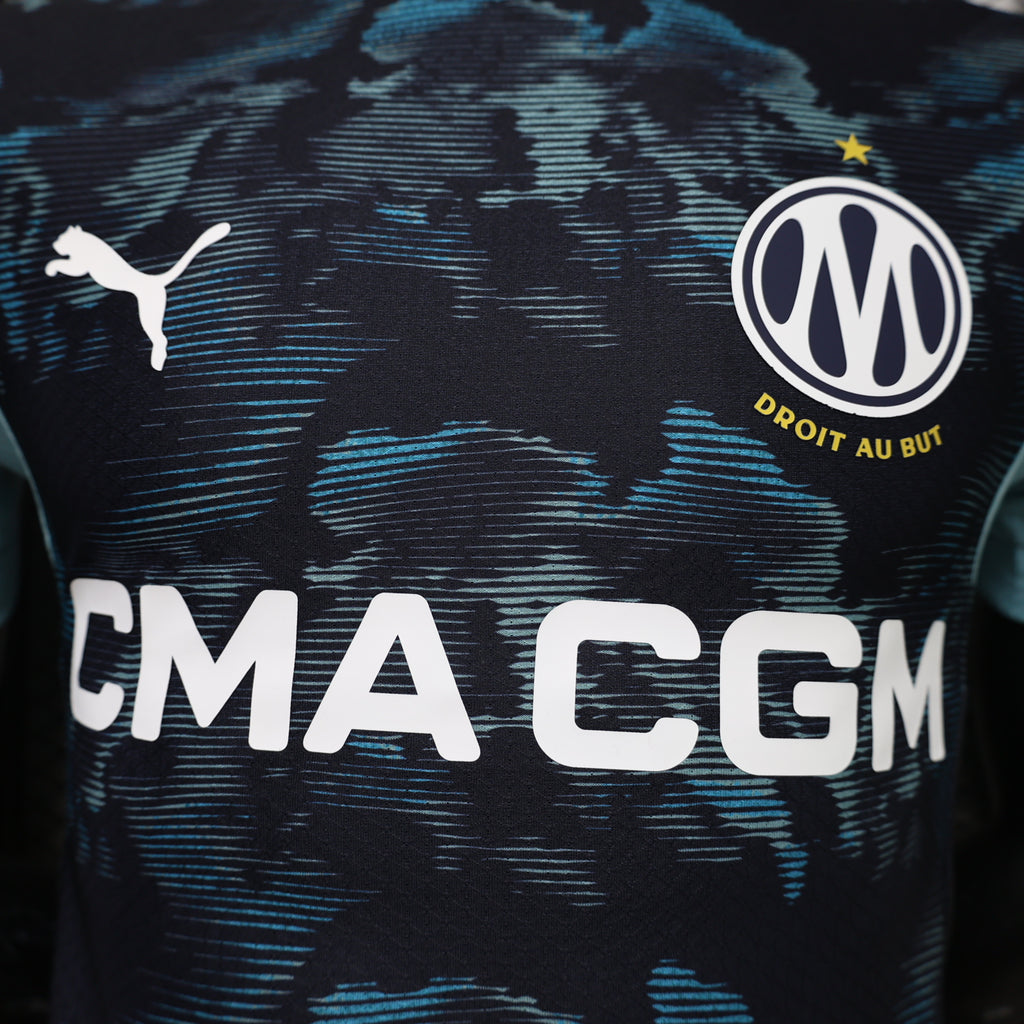 Navy jersey chest close-up with Puma logo, Marseille crest, and CMA CGM