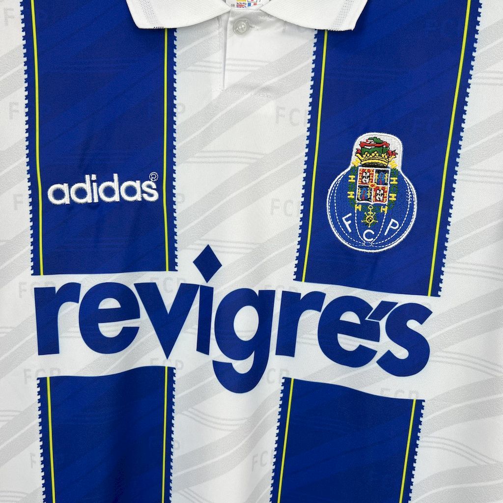 Retro home jersey close-up: revigres sponsor, Adidas logo, and blue/white panels