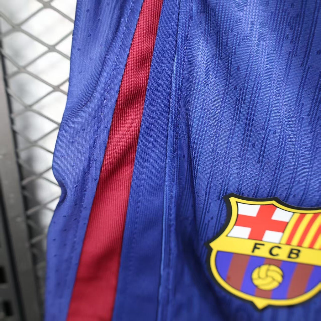 Blue player shorts with FC Barcelona crest patch and red side stripe