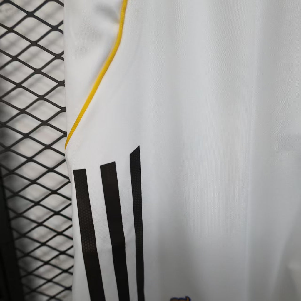 White shorts with black triple stripe design and yellow side trim.