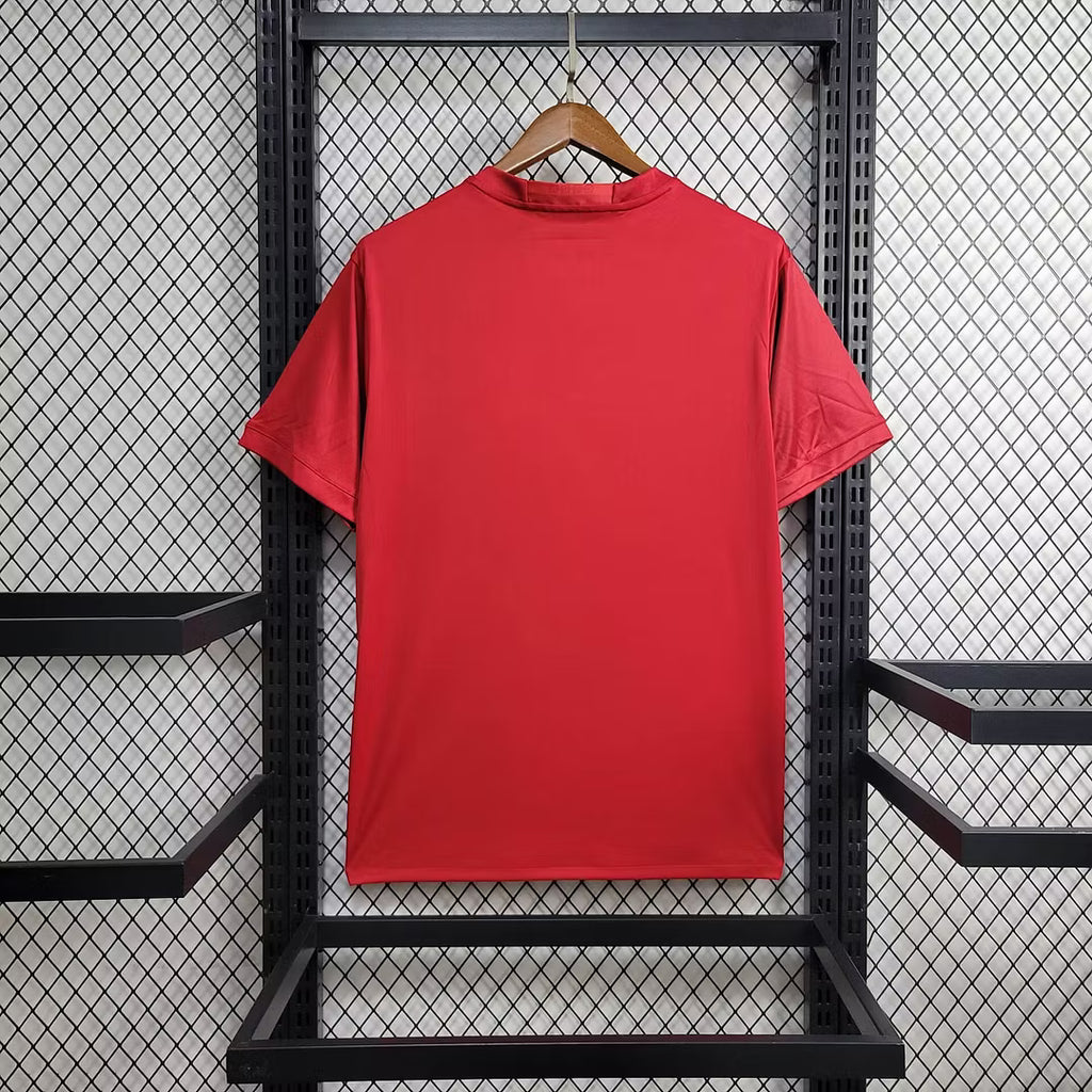 Home football jersey, red crew neck with short sleeves and no visible sponsor