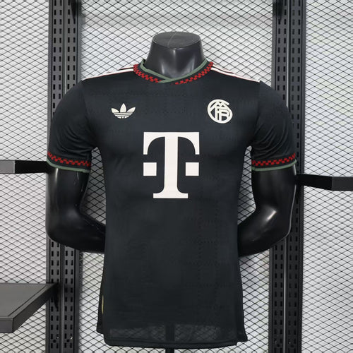 Black Bayern Munich third soccer jersey with red trim, green collar, and large white T sponsor
