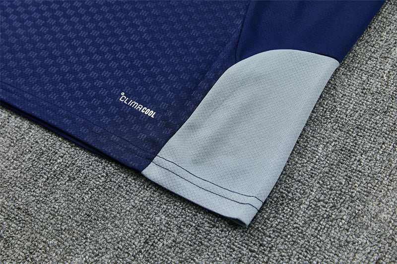 Navy training shorts hem with light gray panel and Climacool branding.
