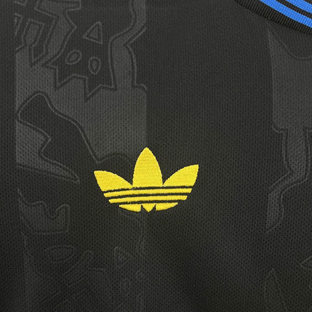 Women's third jersey adidas trefoil logo in yellow on dark fabric.