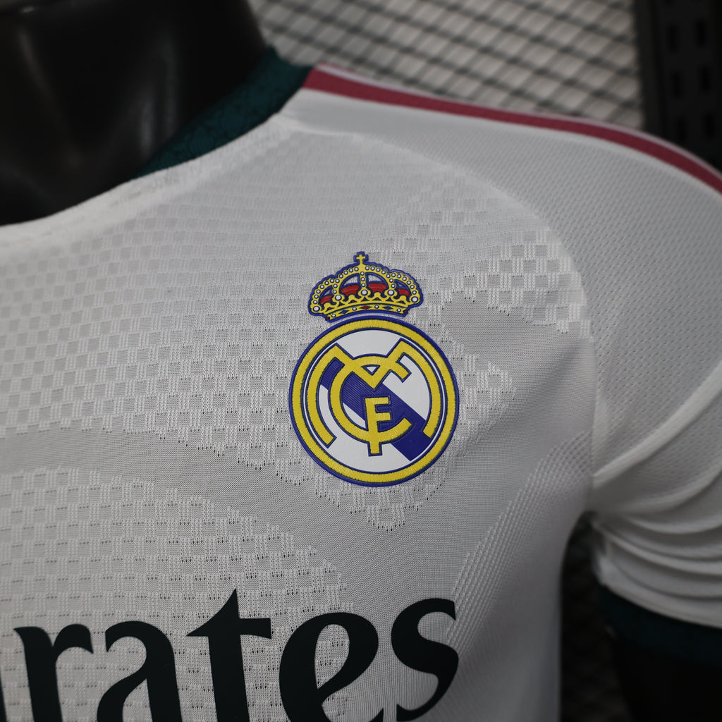 White football jersey upper back with Real Madrid crest and partial “Emirates” text