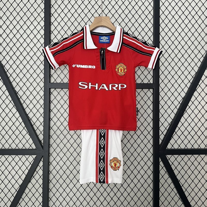 Red kids soccer jersey and shorts set with white collar and Manchester crest