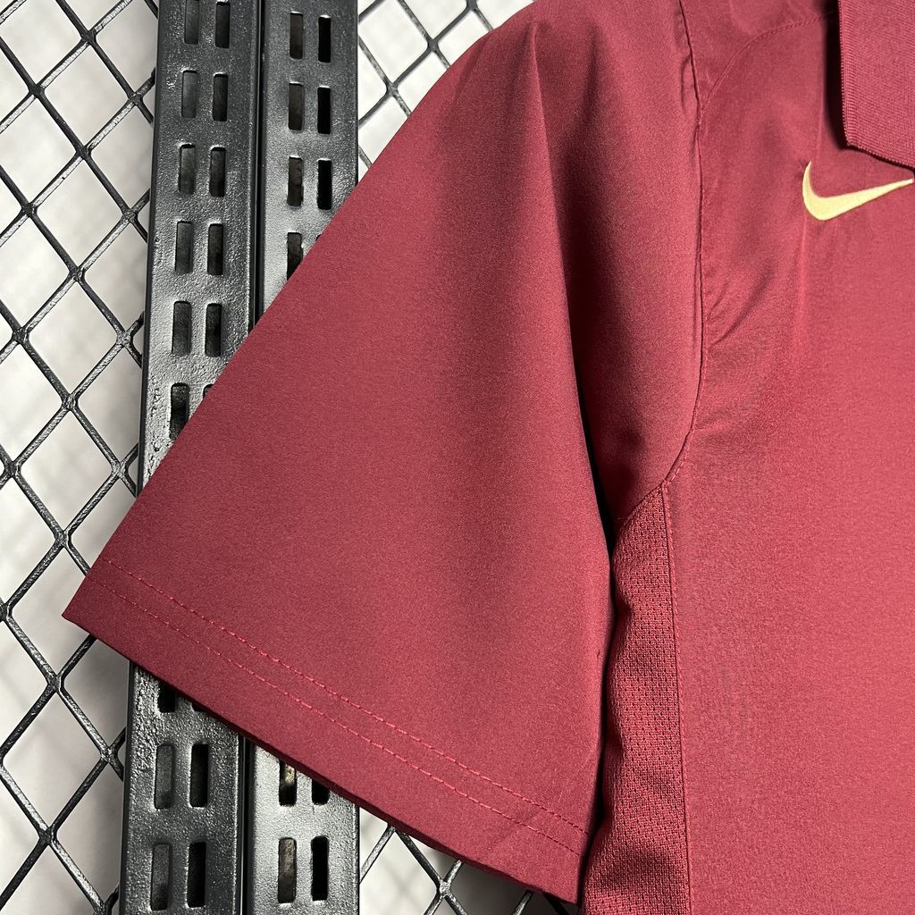 Maroon football jersey sleeve detail with stitched seams and Nike logo