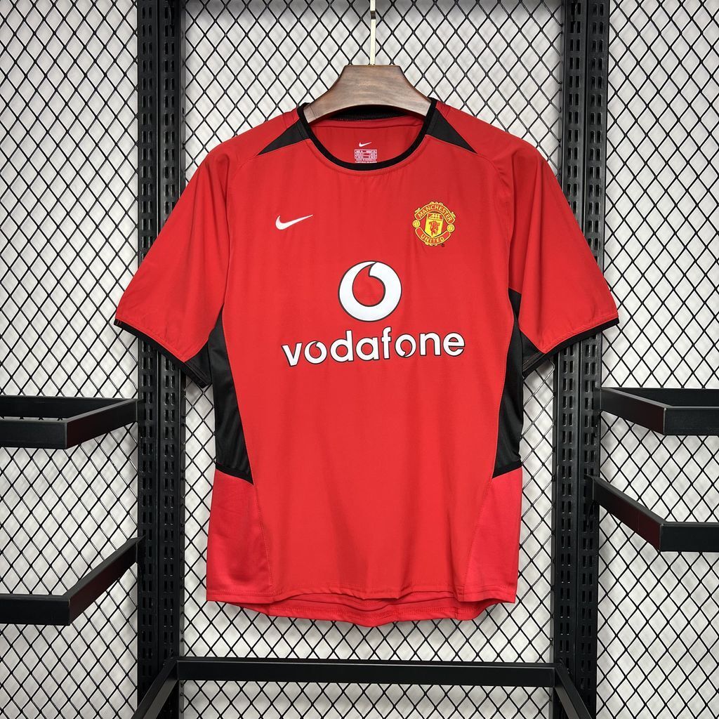 Red Manchester United home football shirt with Nike swoosh, crest, and Vodafone sponsor front