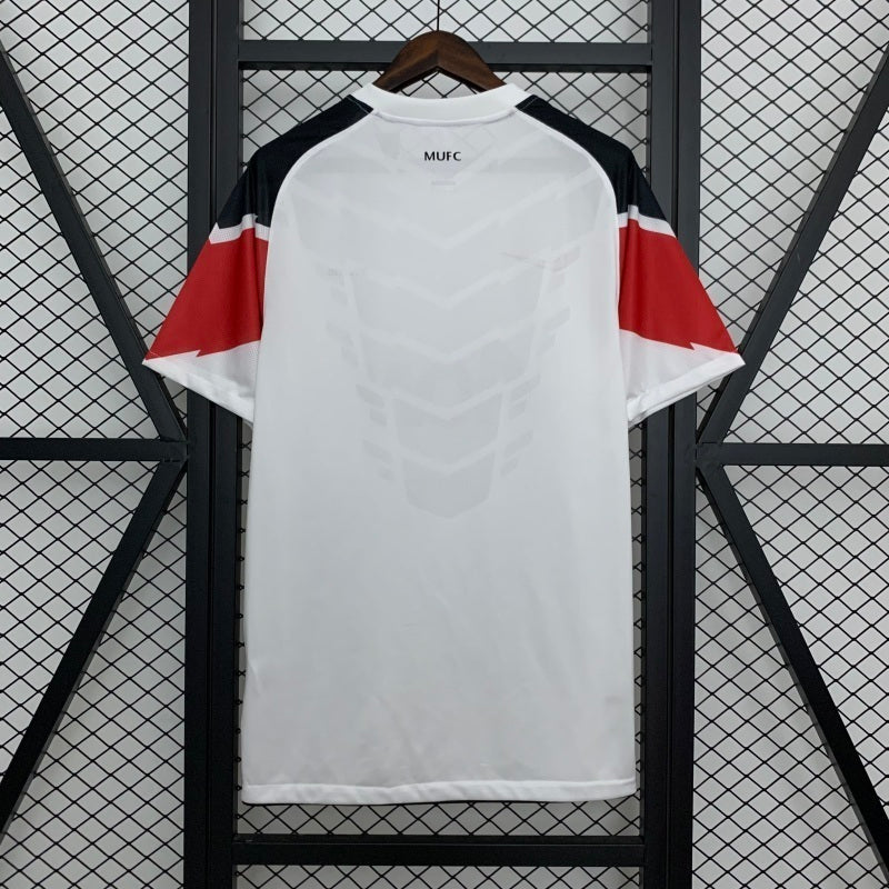 White away football jersey with red sleeve accents and MUFC branding
