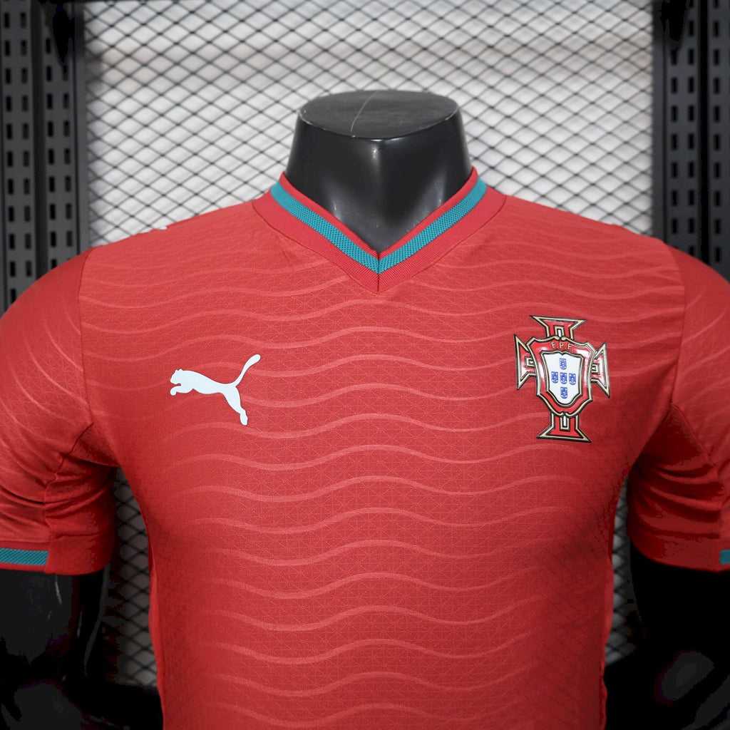 Red soccer jersey front with Puma logo and Portugal crest, teal collar trim