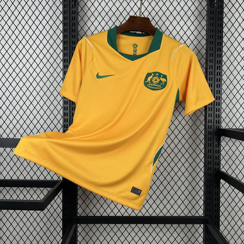 Yellow Australia home soccer jersey with green trim, Nike logo, and crest