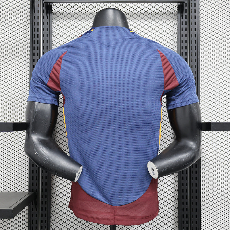 Blue soccer jersey on mannequin, back view with maroon side panels and yellow collar accents