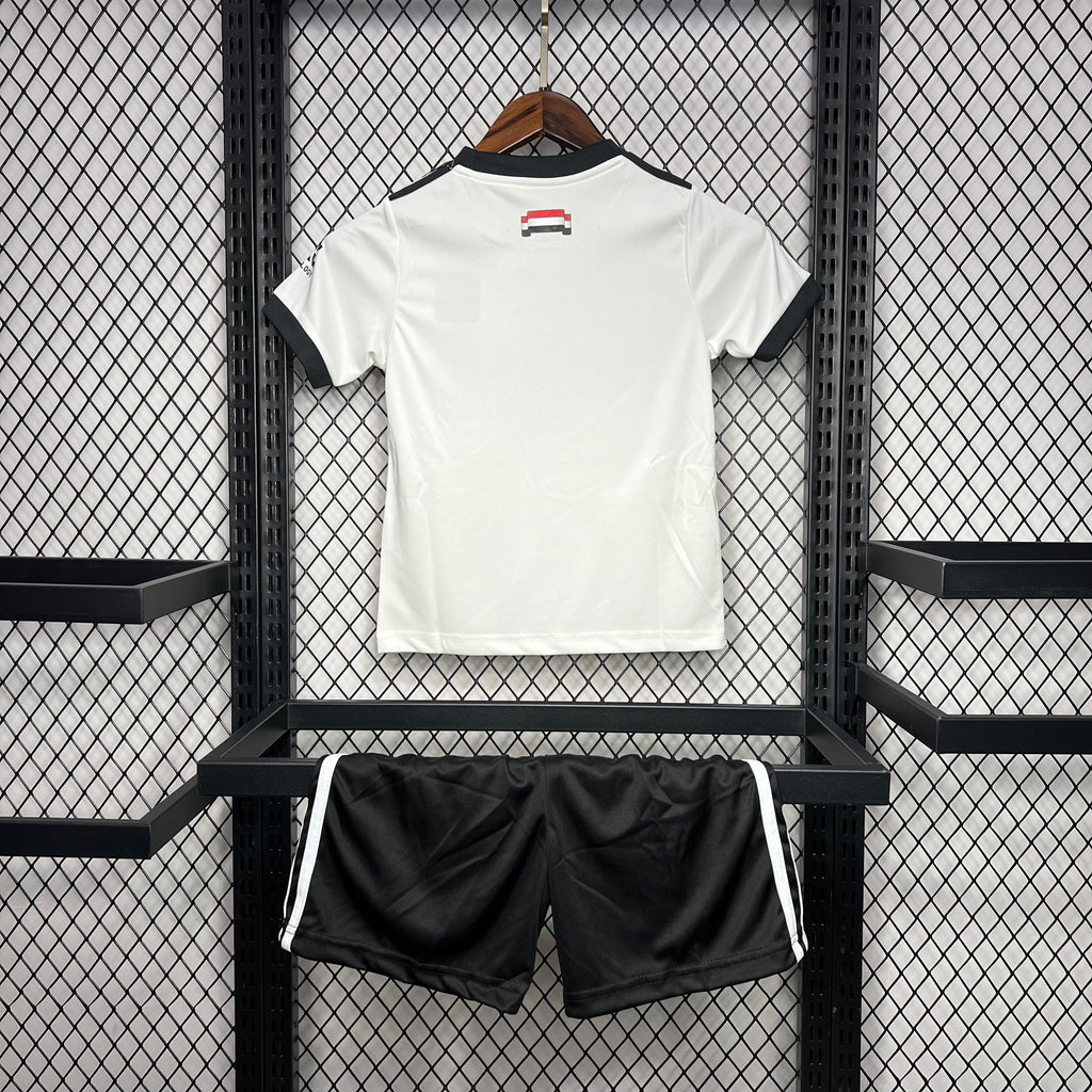 Kids football kit: white back jersey with crest and matching black shorts