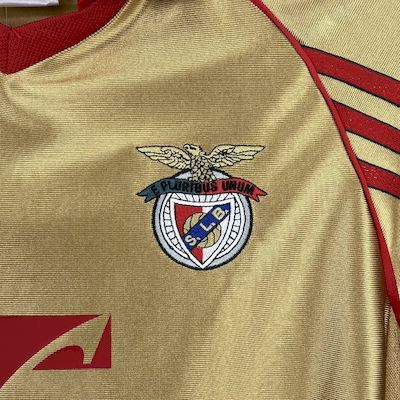 Yellow soccer jersey with Benfica crest emblem and red trim details