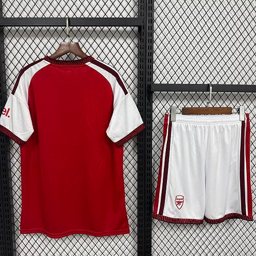 Kids football kit on hangers: red back jersey with white sleeves and white striped shorts