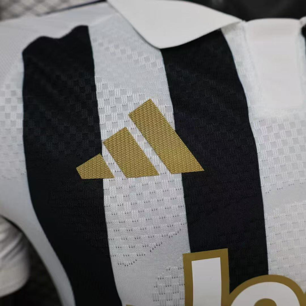 Juventus home jersey close-up with adidas logo on black-and-white striped fabric