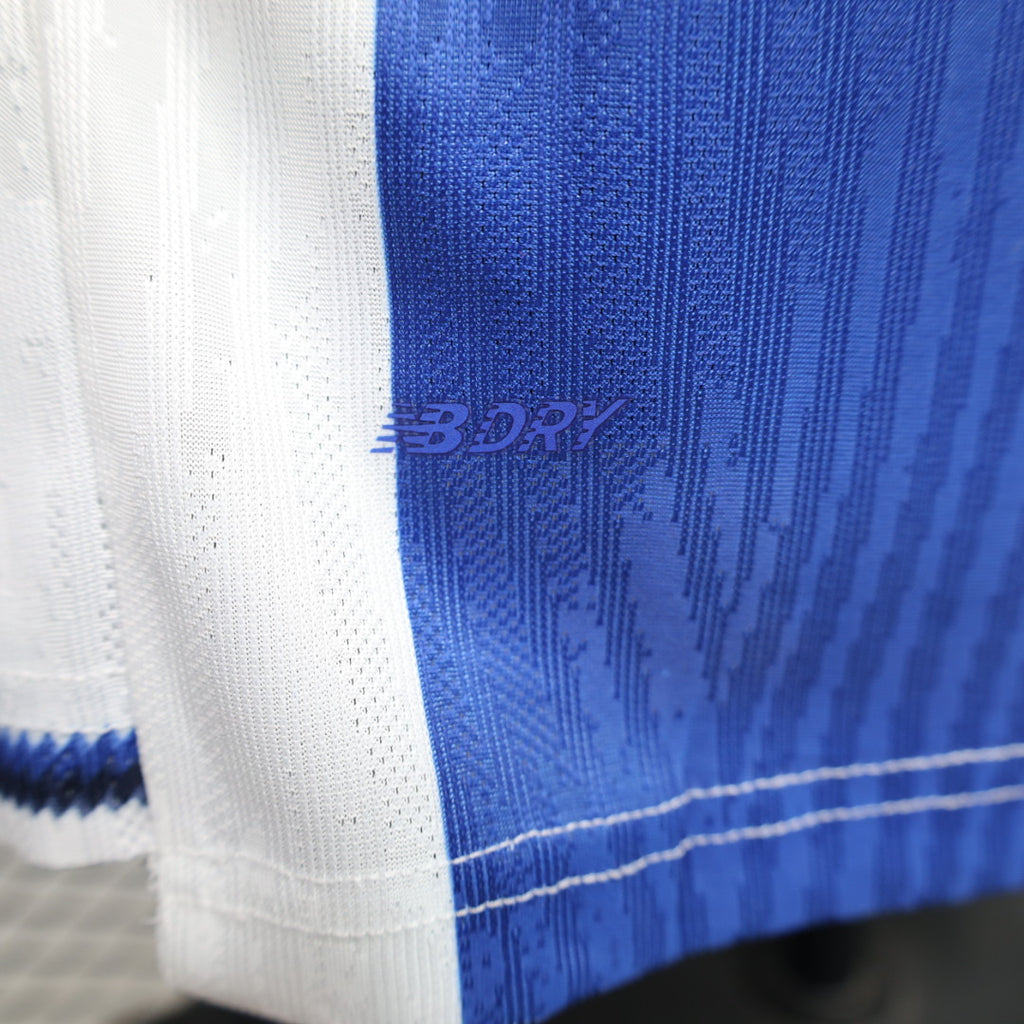 Blue-and-white football jersey fabric with textured pattern on side panel