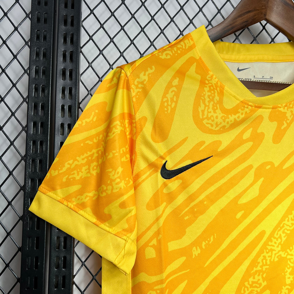 Yellow goalkeeper jersey with Nike swoosh on front, crew neck, short sleeves