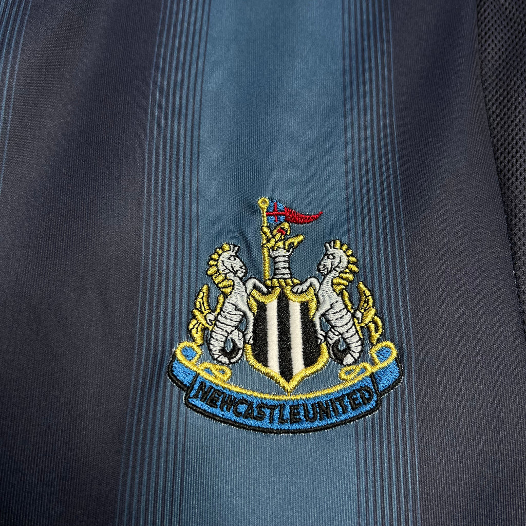 Newcastle crest patch on light-blue stripe panel of away soccer jersey