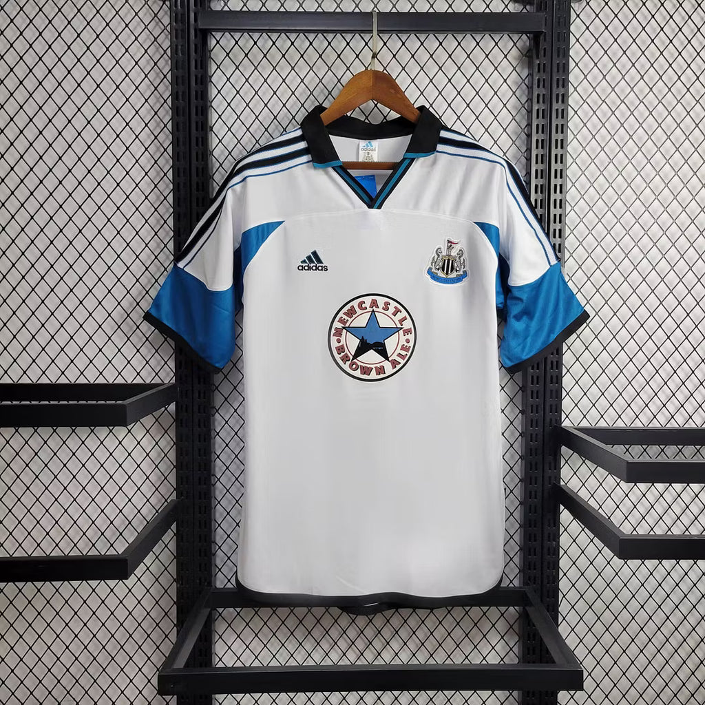 White retro football jersey with blue stripes, Newcastle crest and adidas logo