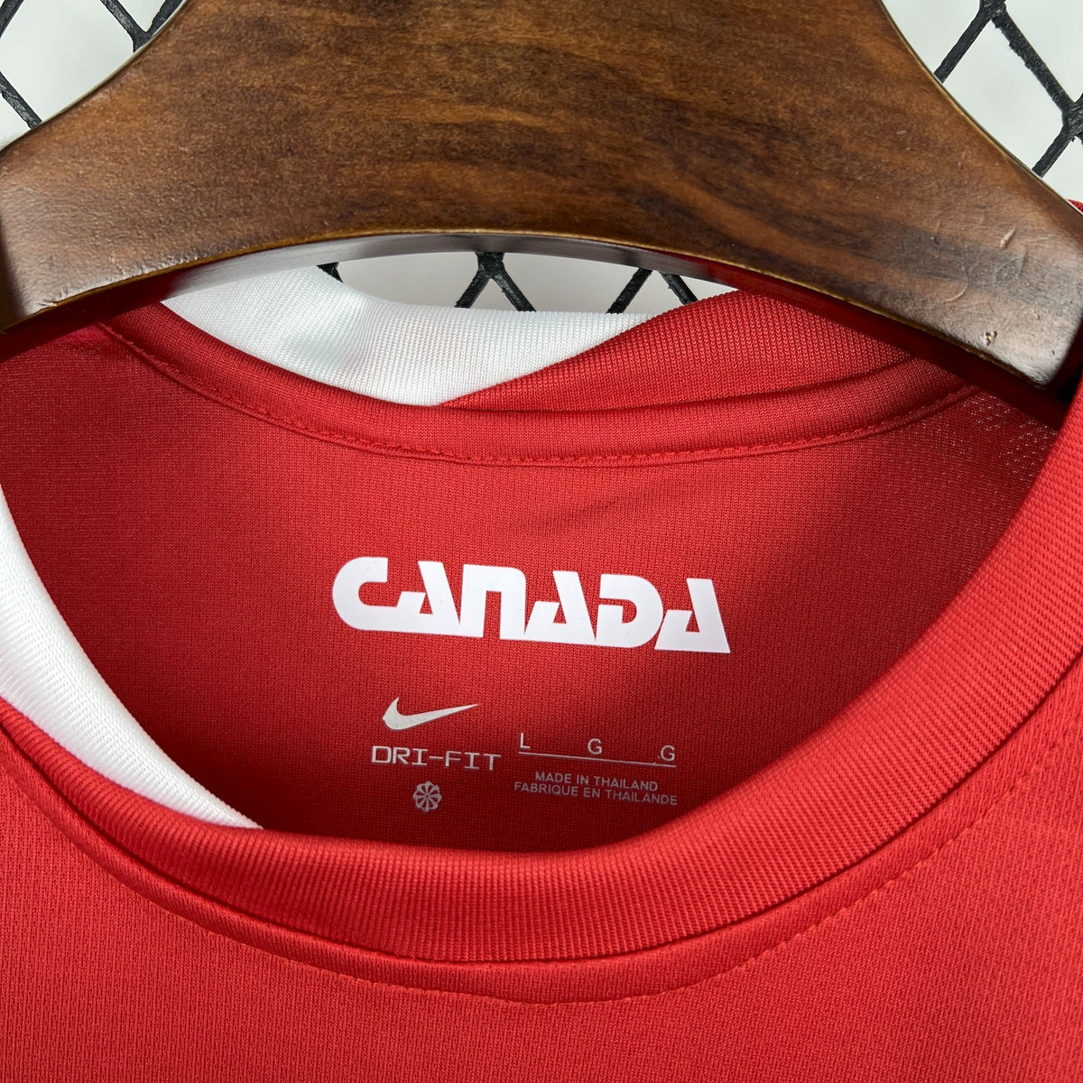 Red jersey inner neck shows CANADA text and Dri-FIT label details.