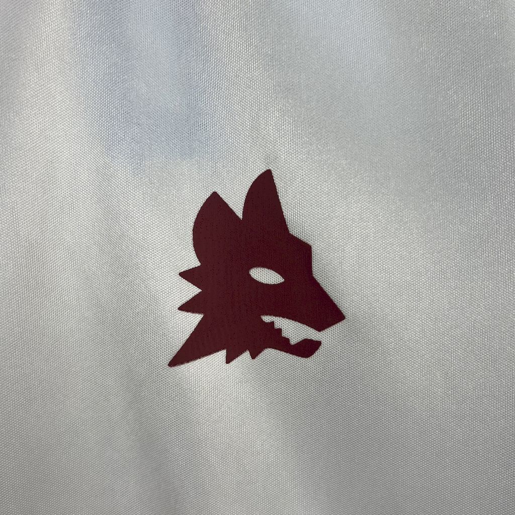 White soccer jersey with maroon animal crest emblem