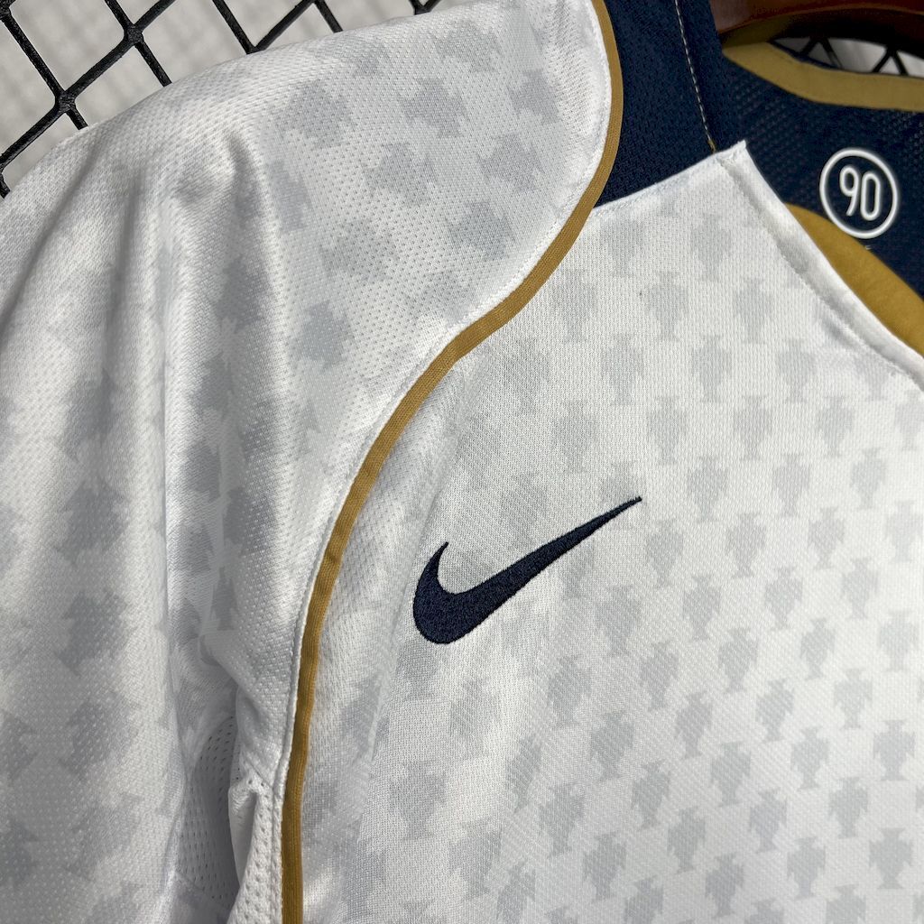 White Portugal away soccer jersey with Nike swoosh and gold-trim edging
