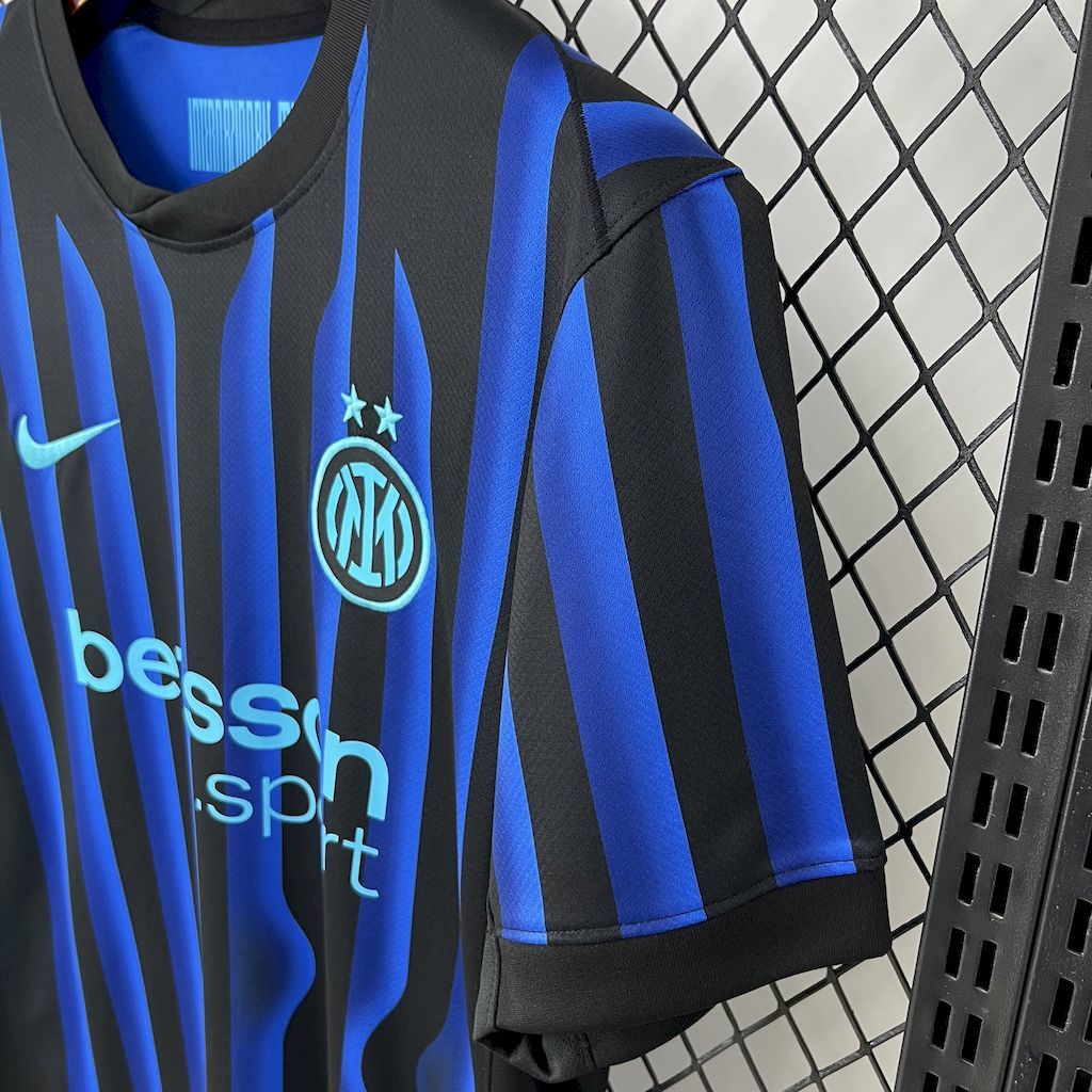 Inter Milan fan jersey sleeve detail with Inter crest, betsson text, blue and black stripes