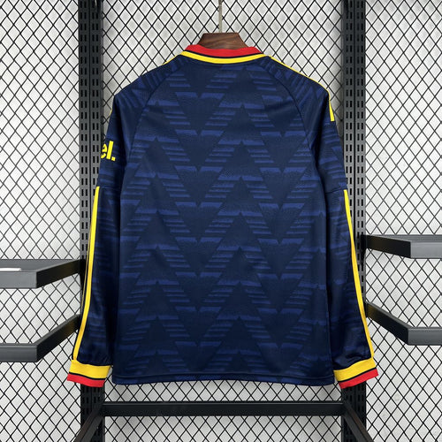 Navy long-sleeve football jersey back with yellow side stripes and red collar trim