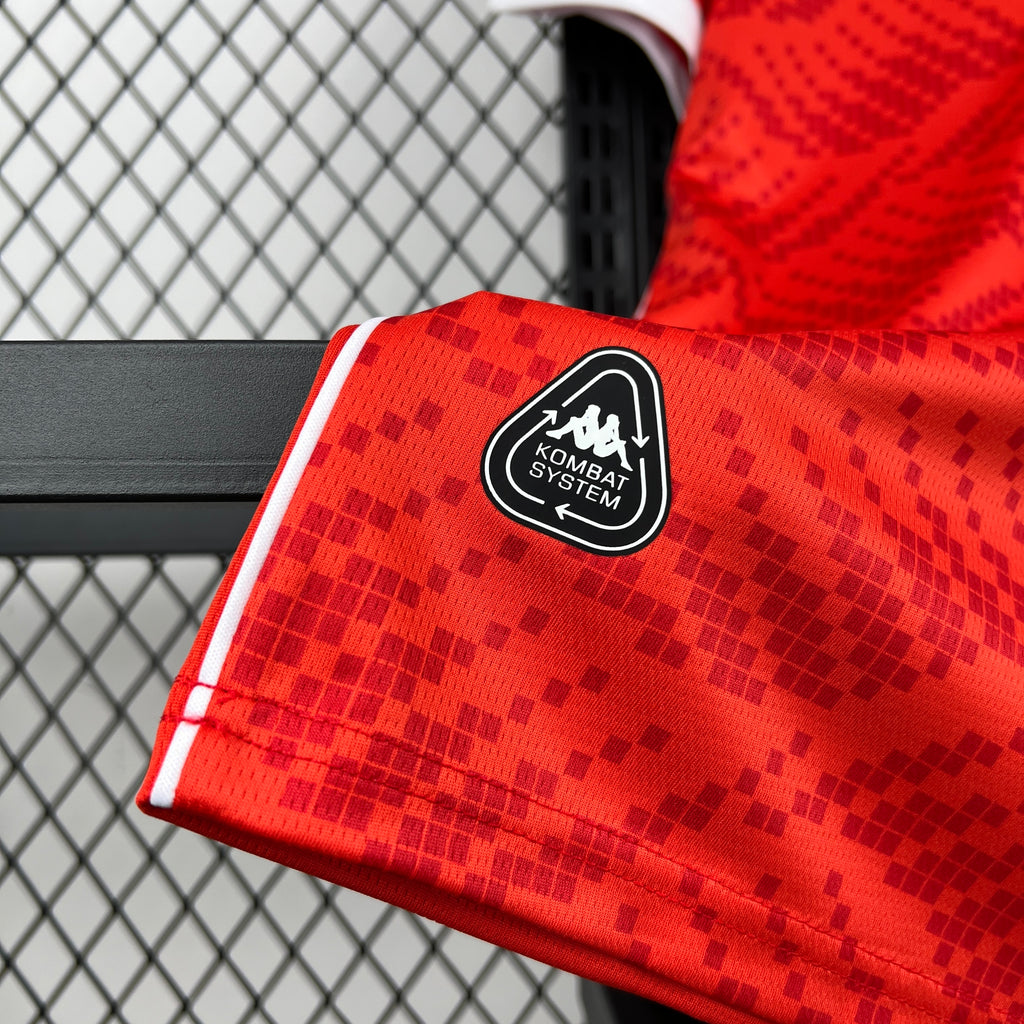 Red jersey shoulder with KOMBAT SYSTEM patch and white sleeve stripe