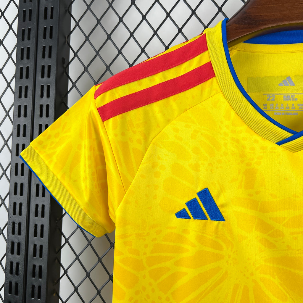 Yellow jersey shoulder view with red-yellow stripe trim and blue Adidas logo