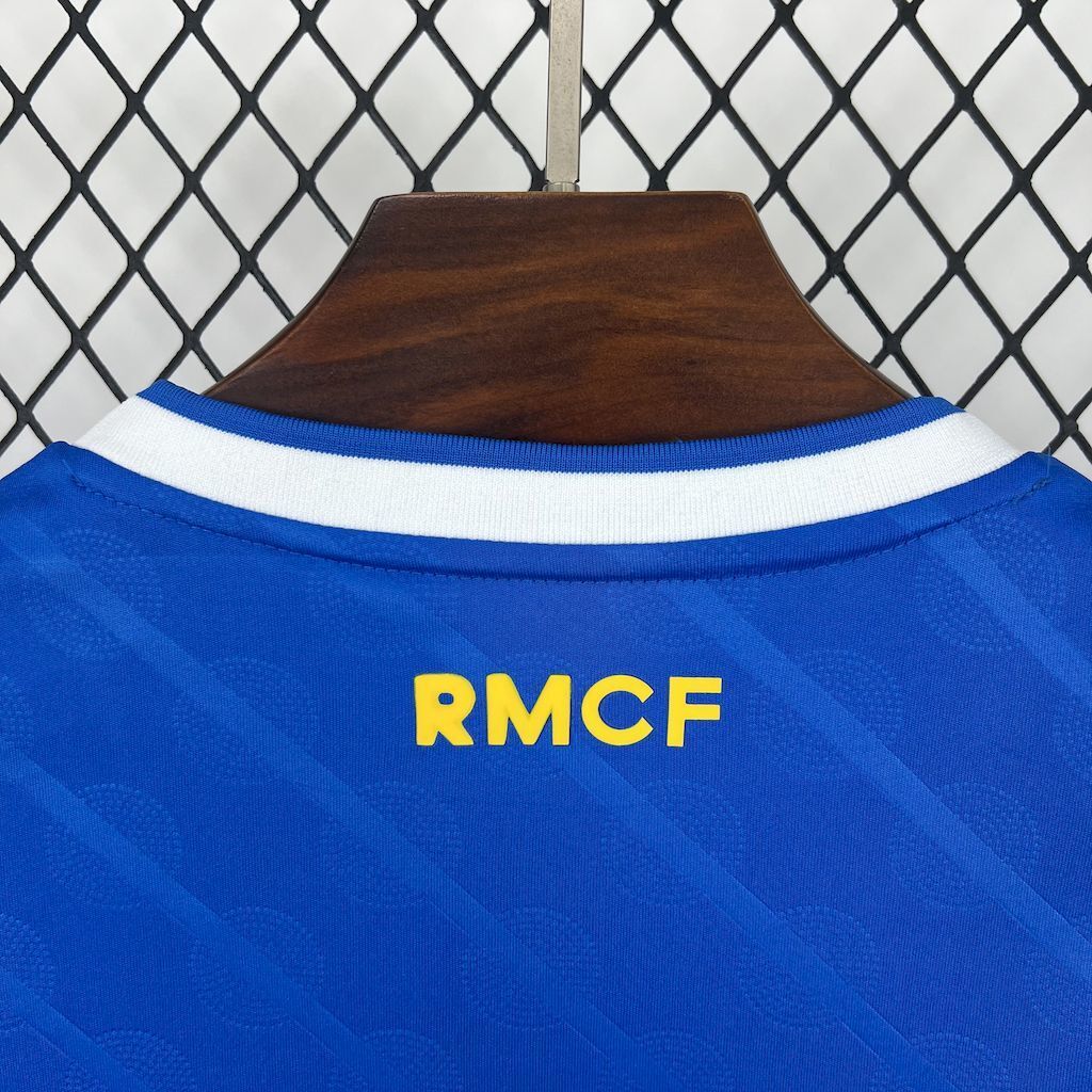 Blue women's soccer jersey back with RMFC letters and white collar stripes