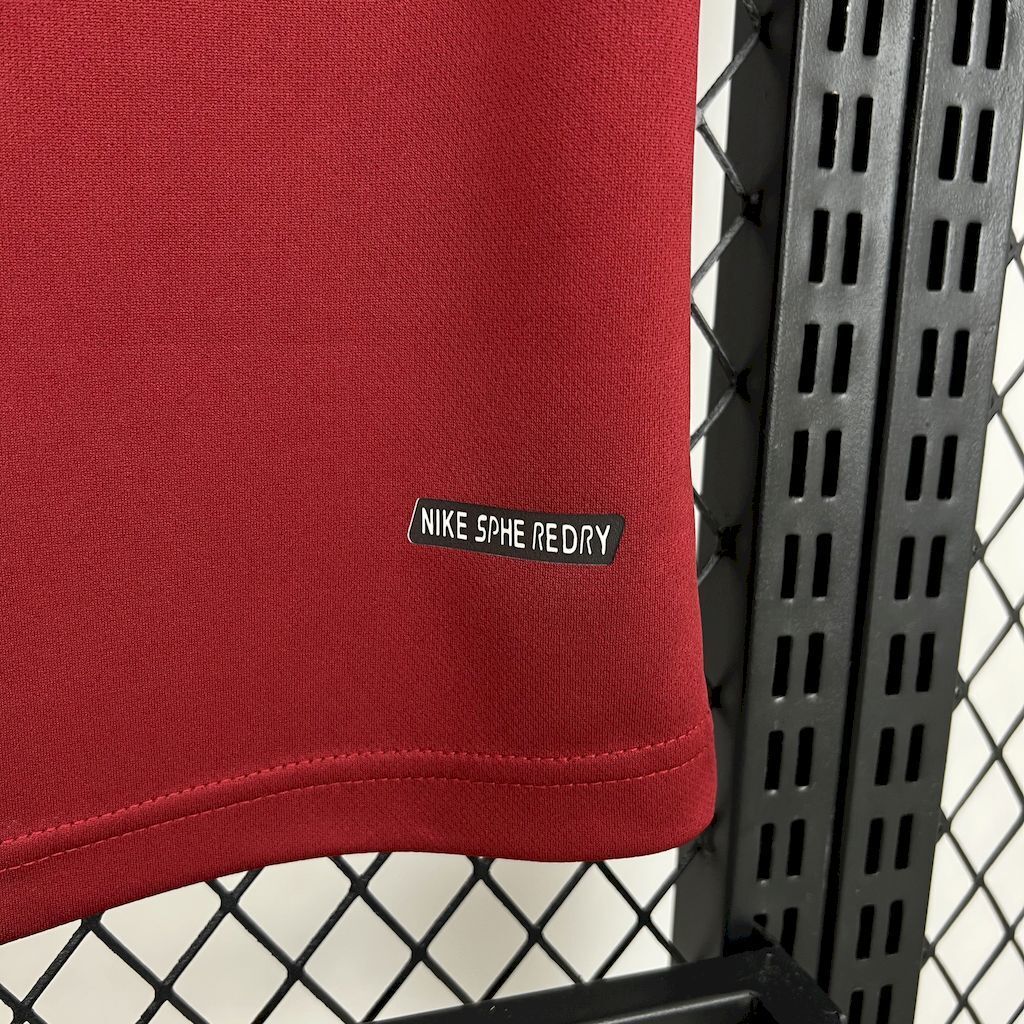 Maroon jersey hem with small Nike moisture-wicking label near the edge
