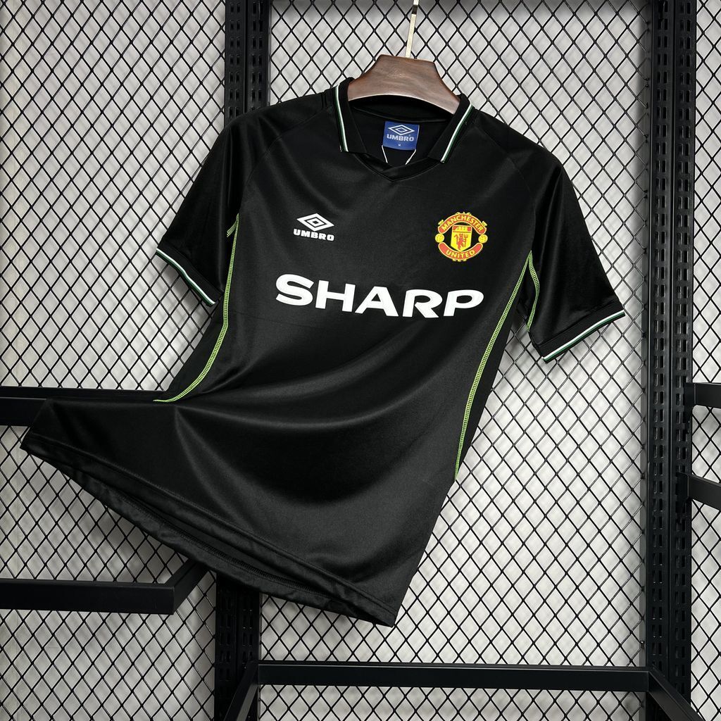 Black Manchester United third soccer jersey, SHARP sponsor and club crest on chest