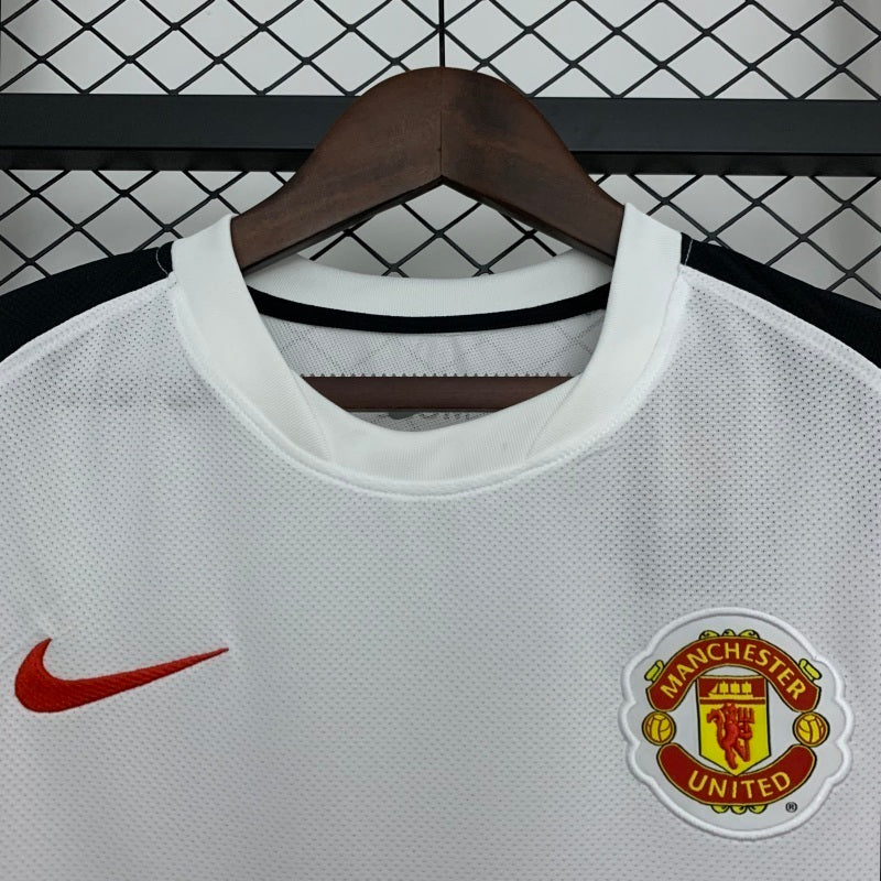 White away football jersey collar with Manchester United crest and red Nike swoosh