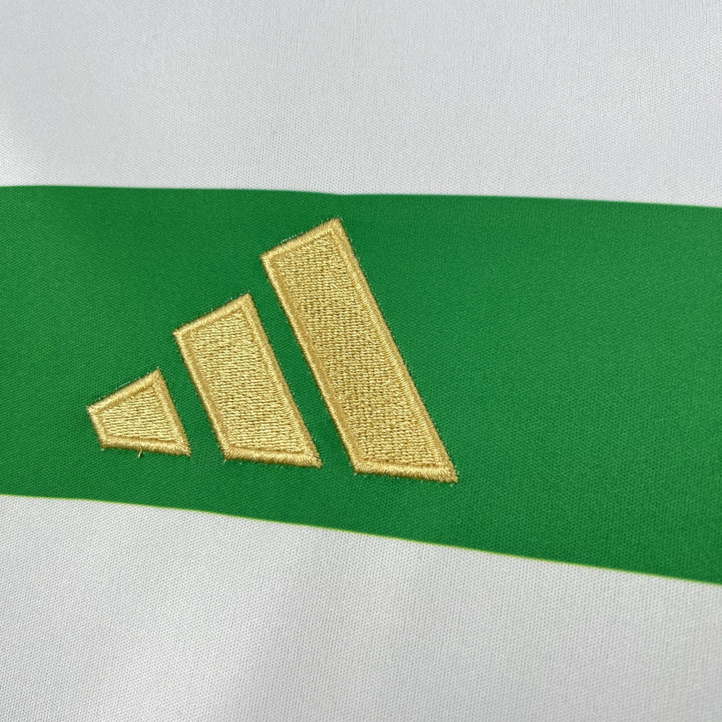 Gold adidas logo on green section of a green and white striped football shirt