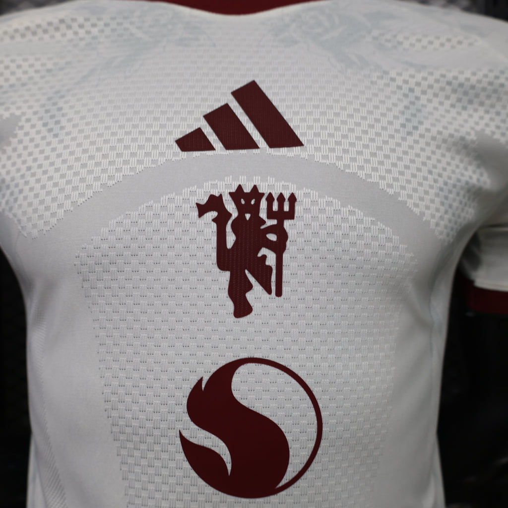 White Manchester United third player shirt back with maroon adidas logo and lion crest
