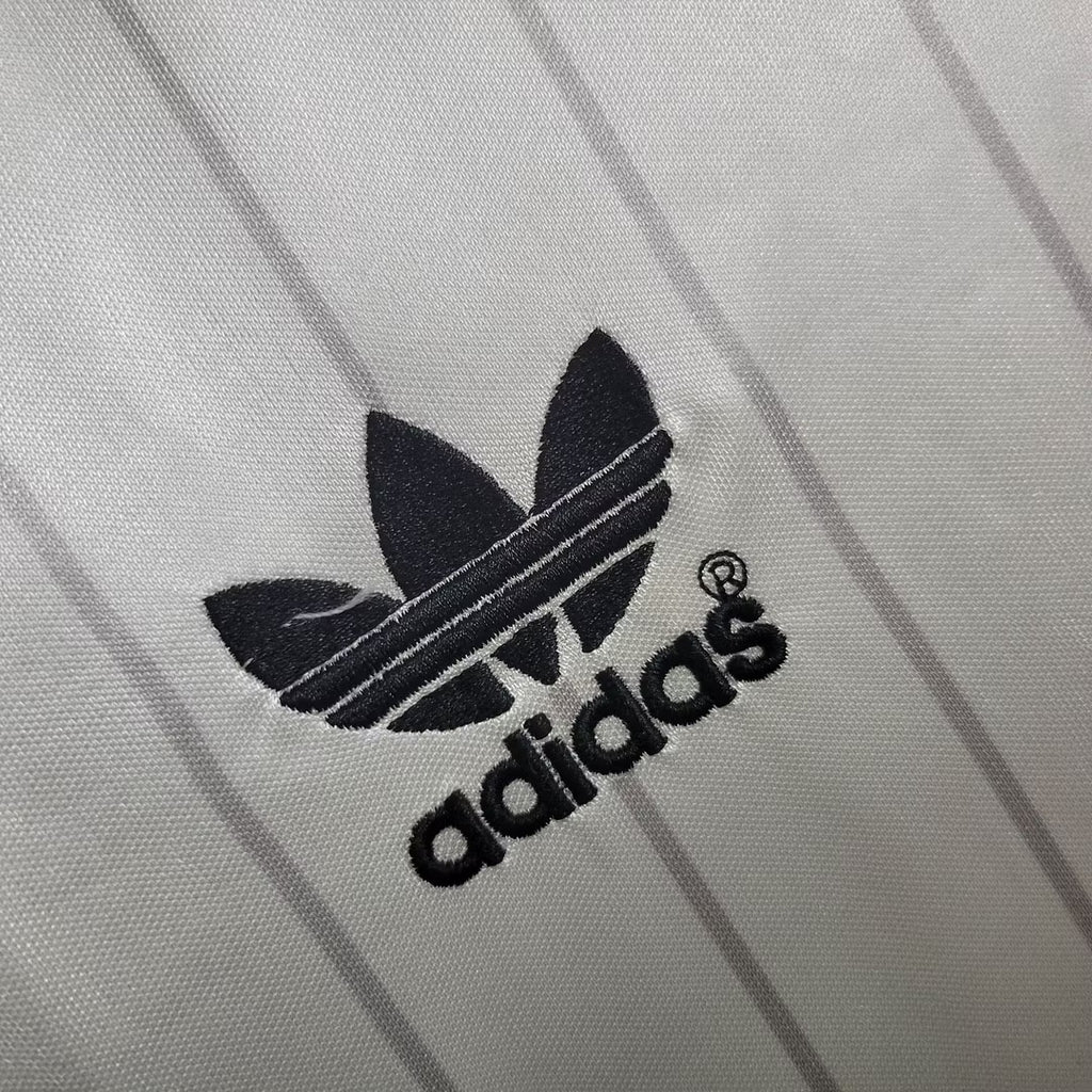 Black adidas logo on white jersey fabric