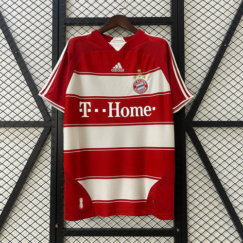 Red and white Bayern Munich home soccer jersey with T-Home sponsor and FC Bayern crest
