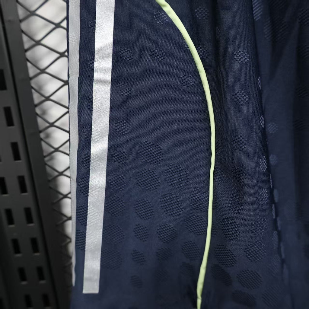 Navy player shorts close-up with white side stripe and small textured dots