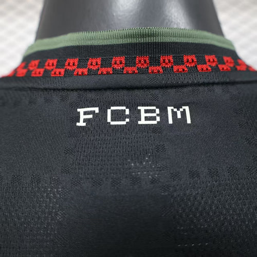 Black jersey collar with red patterned trim and FCbm logo on the back